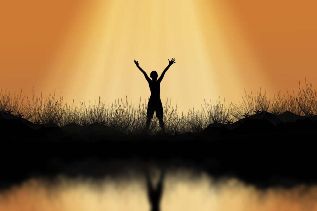 Silhouette of man standing on the mountain raise exposure.